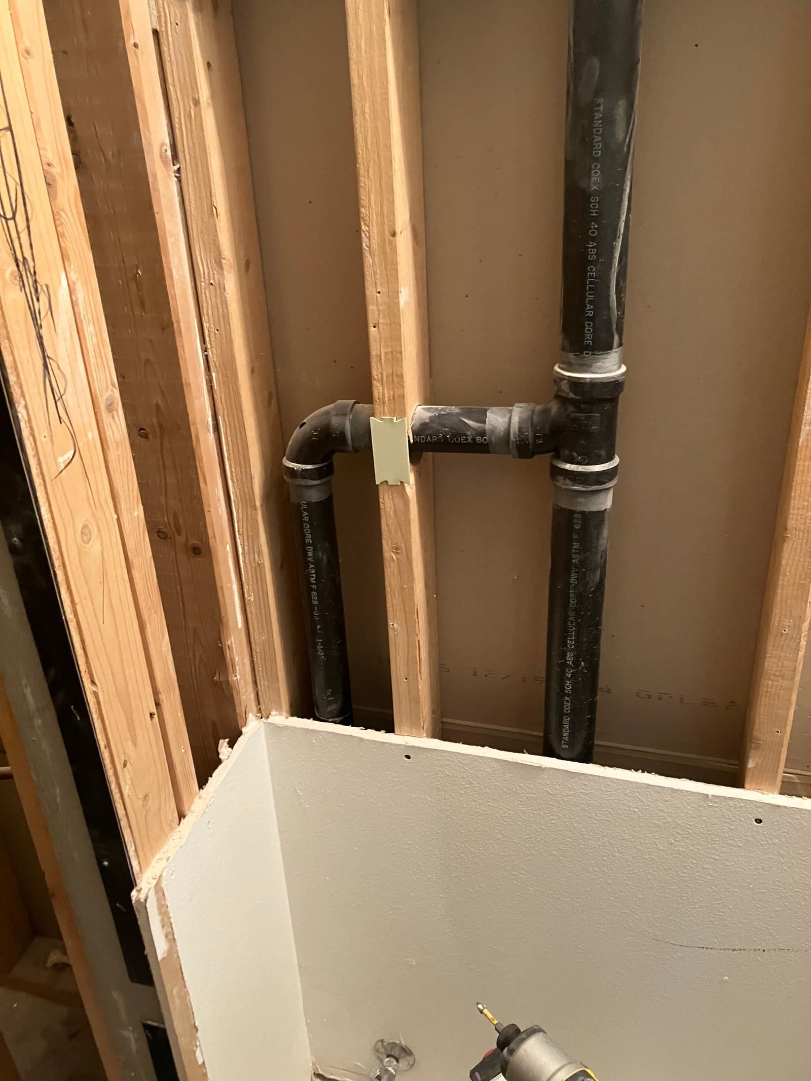 ABS drain waste vent pipe fitting installed during a drain repair