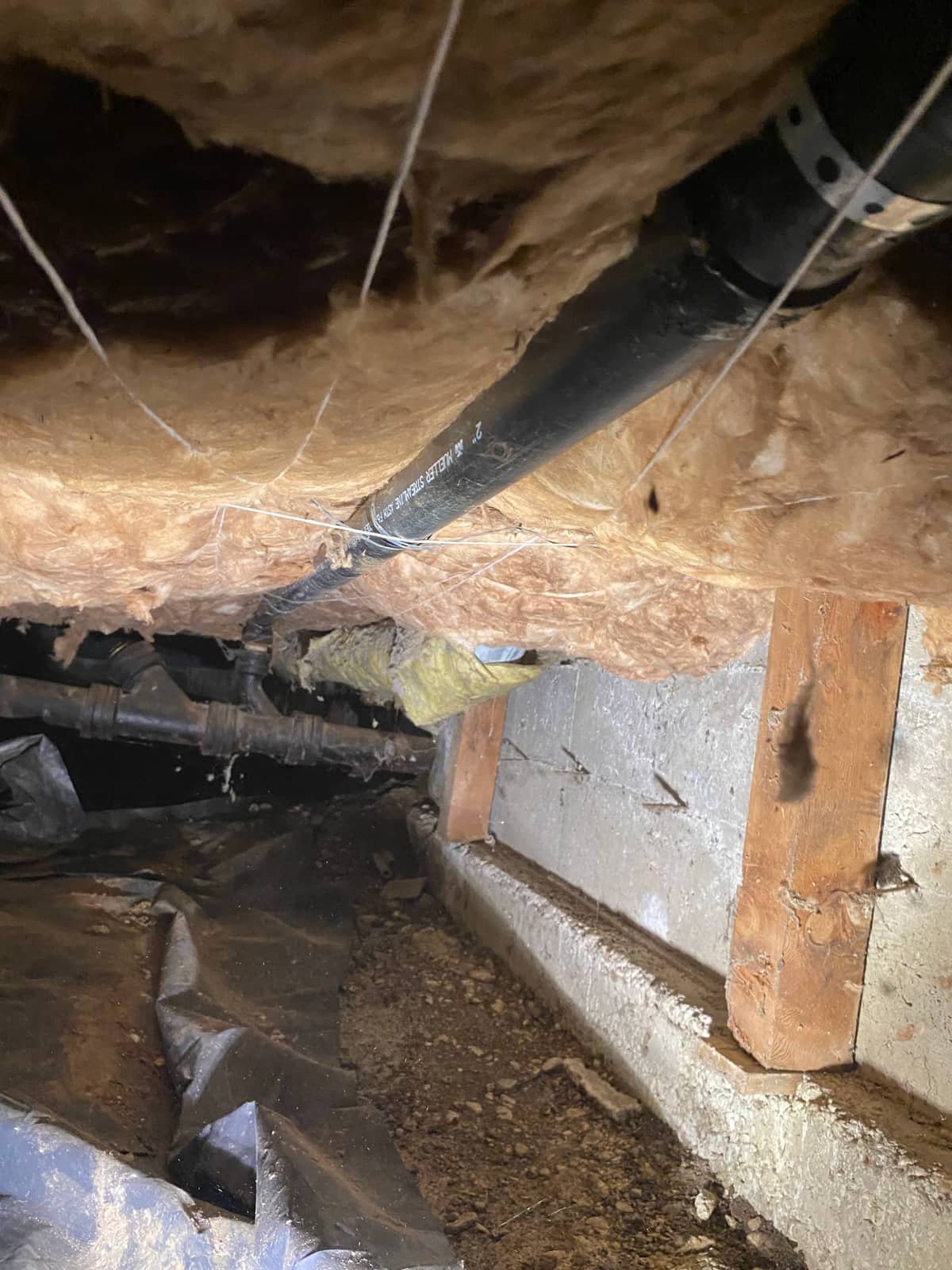 Waste drain pipe routed through a crawlspace during a drain repair