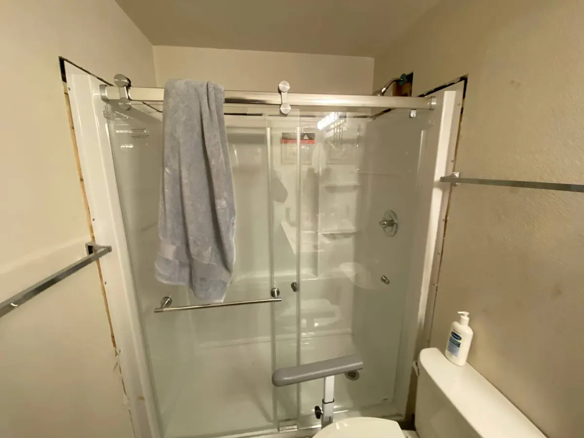 Finished glass shower door installed by Andy's Plumbing & Drain