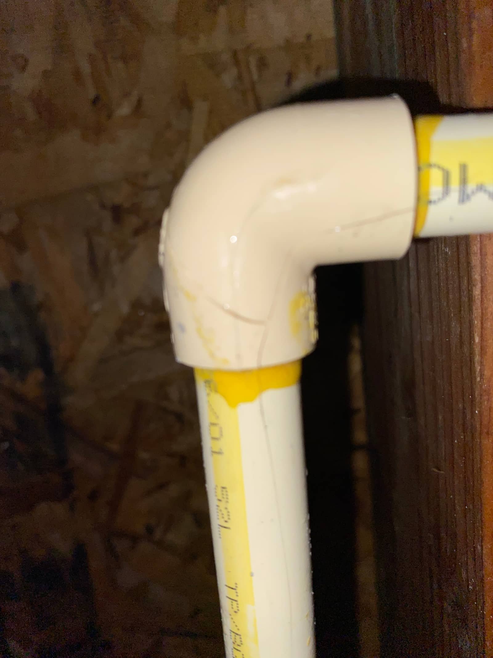 Close-up of a glued PVC drain fitting installed by Andy's Plumbing & Drain