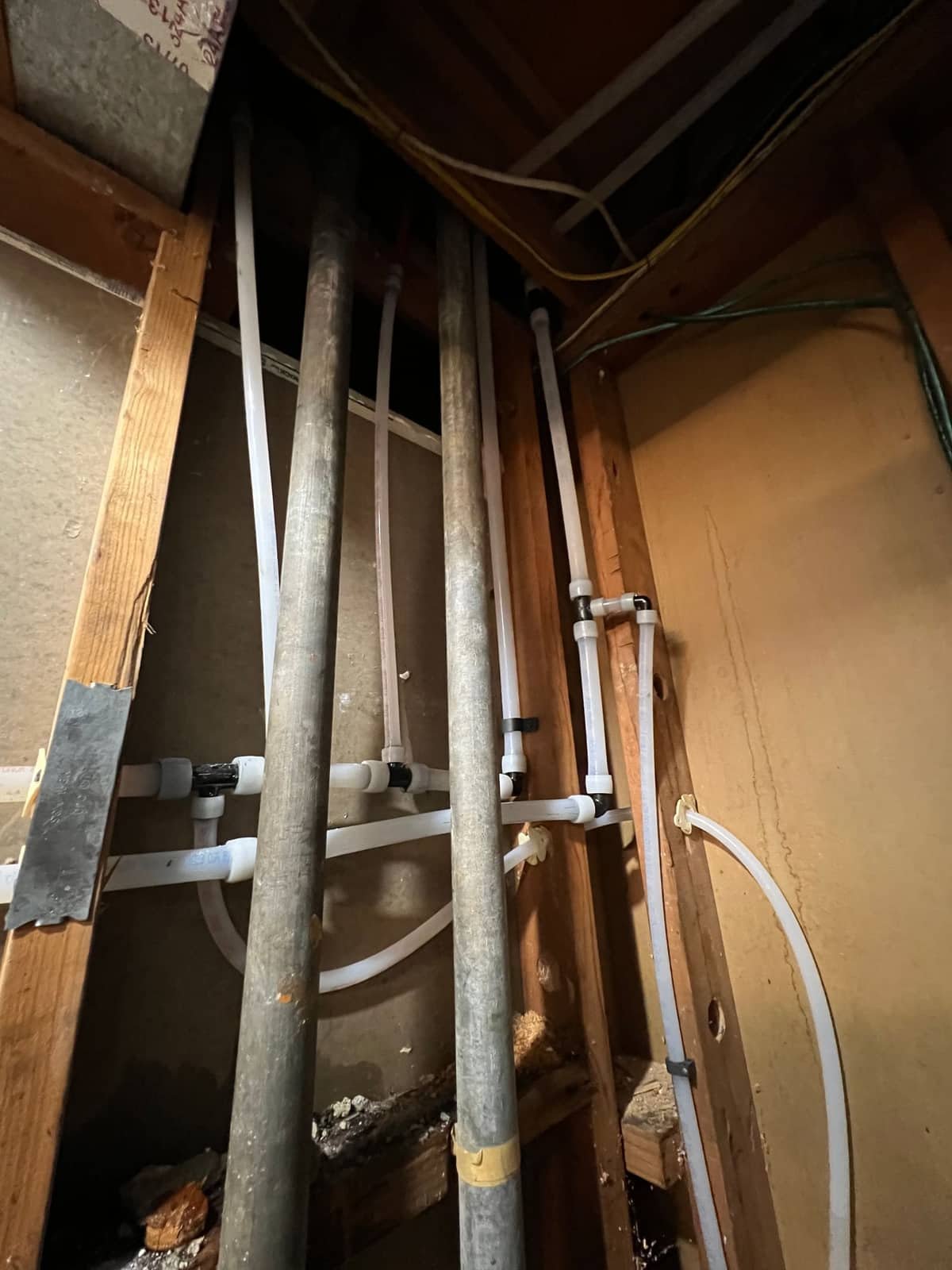 Tankless water heater installed by Andy's Plumbing & Drain, PEX supply lines routed and secured