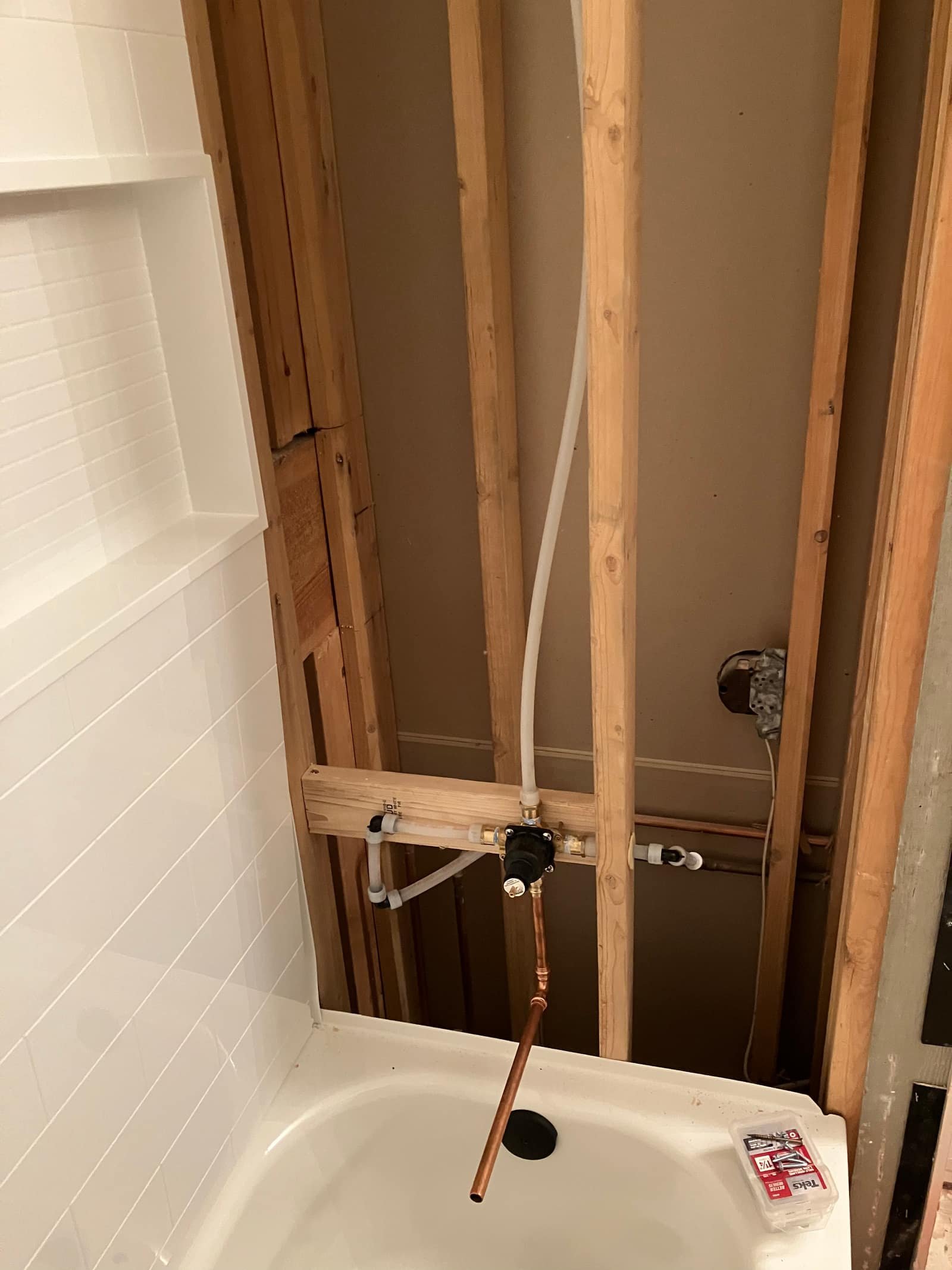 Tub valve rough-in with copper and PEX supply lines during a repipe