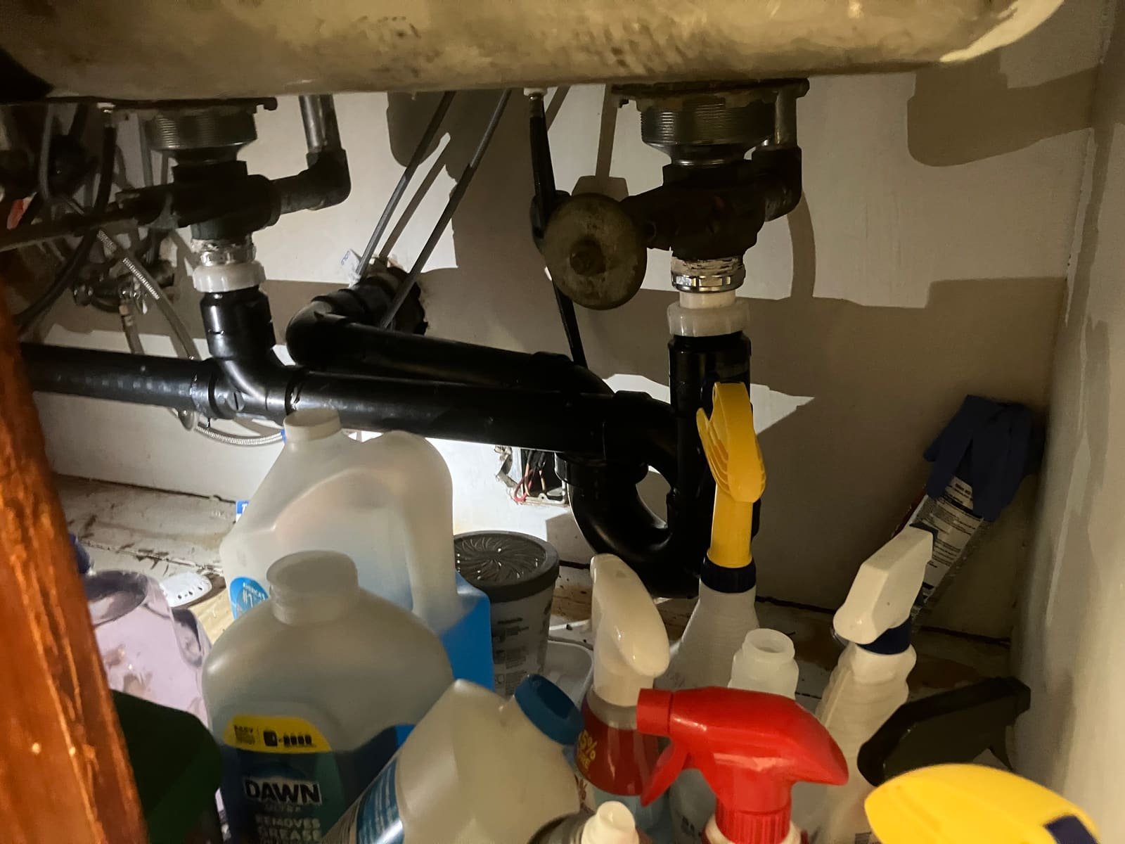 Under-sink drain and garbage disposal plumbing installed by Andy's Plumbing & Drain
