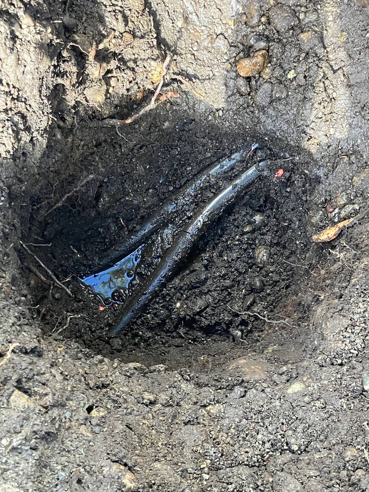 Water line exposed in an excavated trench during a line repair